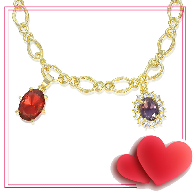 A vintage gold necklace with red and purple synthetic gemstones